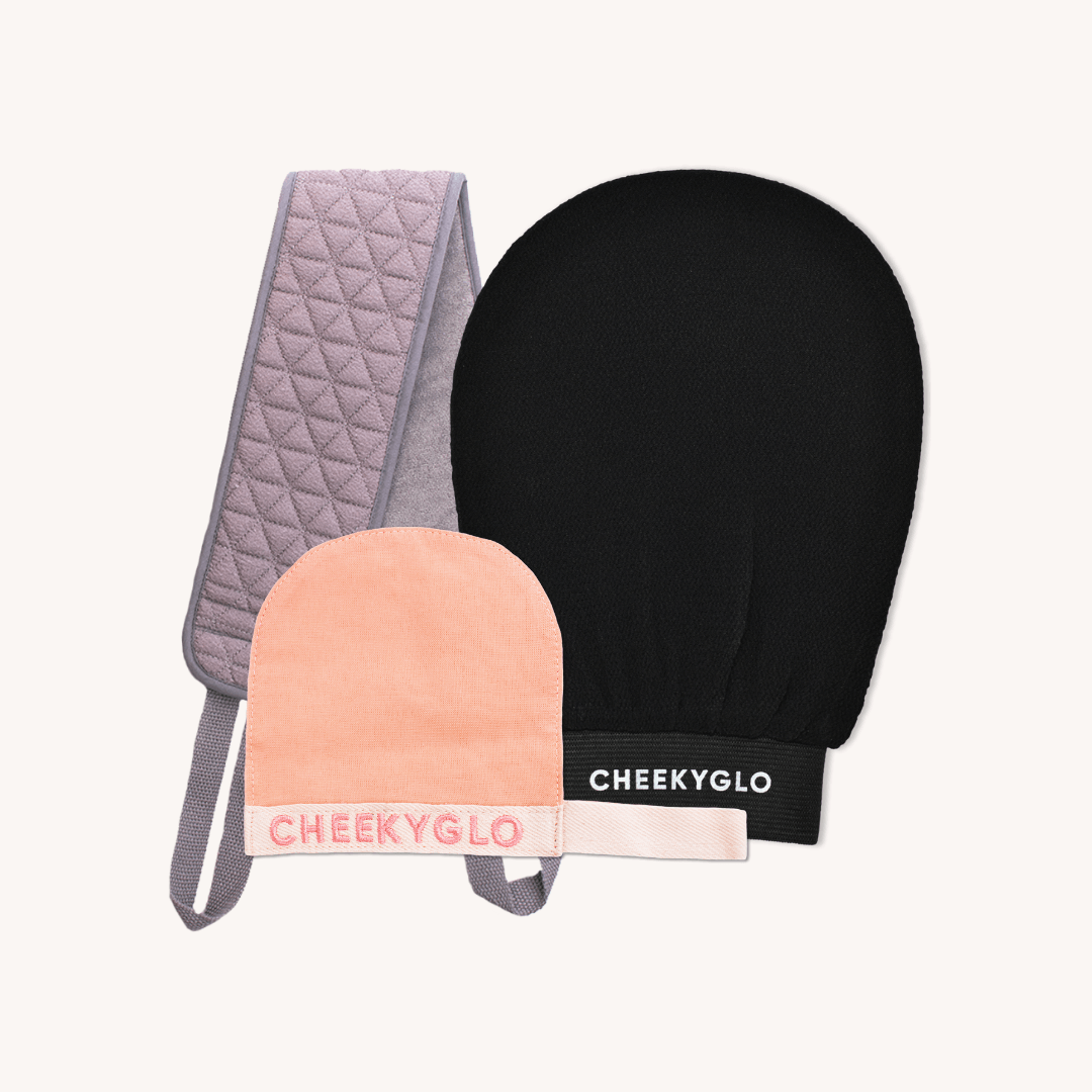 Introducing the Cheekybro Set by CheekyGlo—a skincare collection featuring a quilted grey exfoliating strap, a black exfoliating glove, and a peach-colored makeup-removing mitt with "CHEEKYGLO" branding—perfect for your self-care routine.